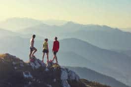 Trail runners atop a mountain peak 