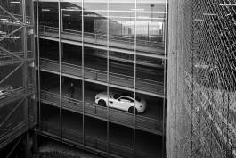 White sports car in Multi-level parking garage 