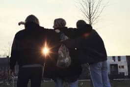 three girls together at sunset 