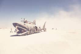 shark-shaped vehicle with people on top 