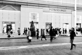 Shoppers walking outside store 