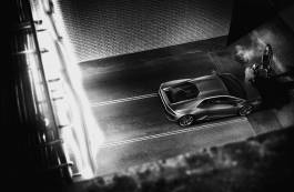 Car and person in dimly lit street 