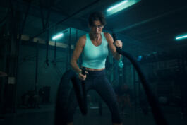 Woman exercising with battle ropes 